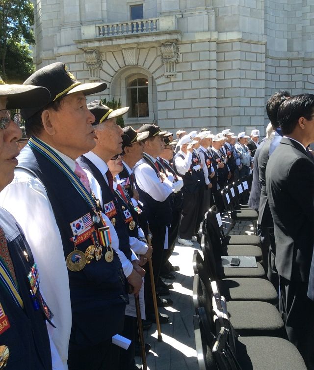 Korean Army veterans listen to national anthem
