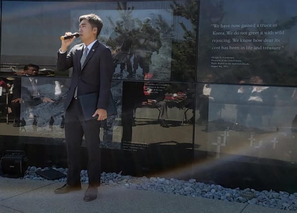 photo of Deputy Consul General of the Republic of Korea speaking in front of the memorial